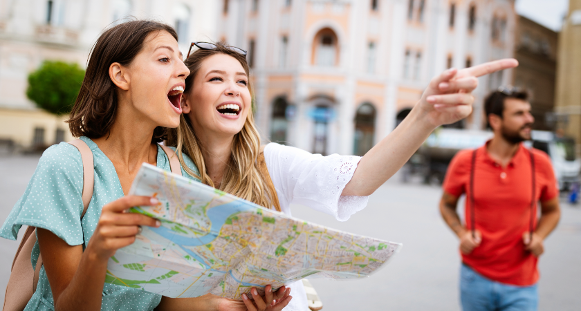 women travelling with a map