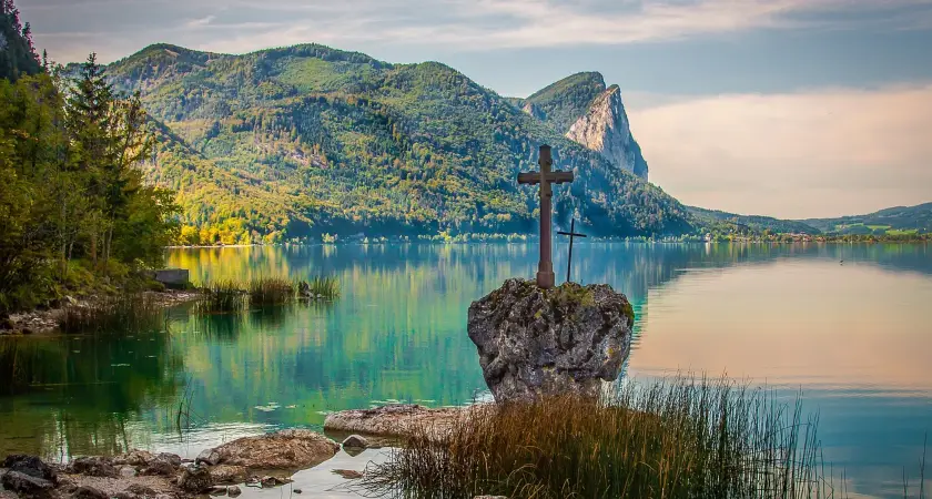 lake with a cross statue