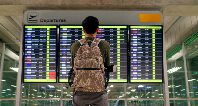 man in front of departure board